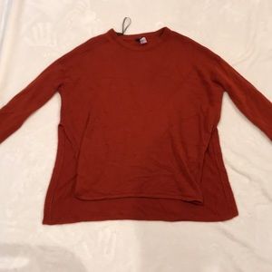 Burnt orange color sweater. Open on the sides.